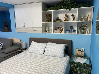 a bedroom with a bed and a blue wall at Sutomore Panorama Studio in Sutomore