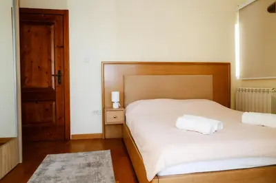a bedroom with two beds and a wooden headboard at Villa Mia in Kotor