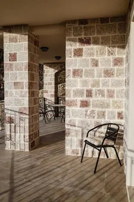 a chair sitting in front of a brick wall at Villa Mia in Kotor