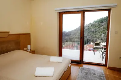 a bedroom with a bed and a balcony with a view at Villa Mia in Kotor