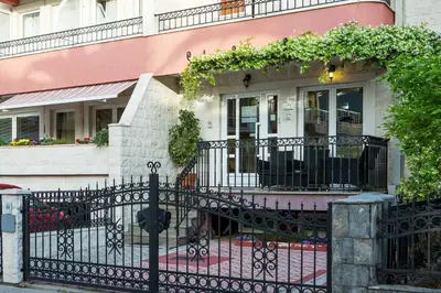 a black fence in front of a house at Apartments Ivona in Budva