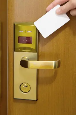a persons hand holding a piece of paper on a door at Apartments Ivona in Budva
