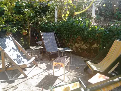 a group of chairs sitting in a yard at Vintage Summer House in Budva