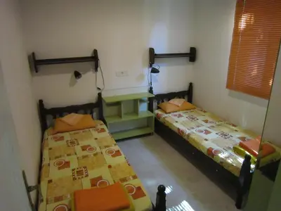 a room with two beds and a table in it at Vintage Summer House in Budva
