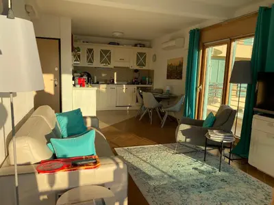 a living room with a couch and chairs and a kitchen at Villa Nova Premium Apartment No 7 in Petrovac na Moru