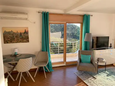 a living room with a table and chairs and a window at Villa Nova Premium Apartment No 7 in Petrovac na Moru