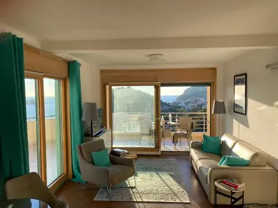 a living room with a couch and chairs and a balcony at Villa Nova Premium Apartment No 7 in Petrovac na Moru
