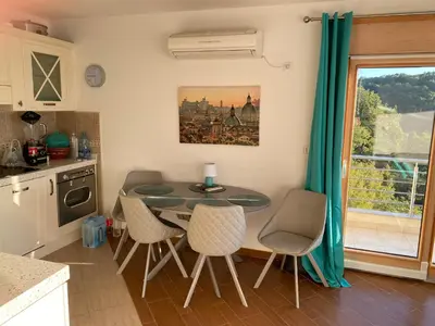 a kitchen with a table and chairs and a window at Villa Nova Premium Apartment No 7 in Petrovac na Moru