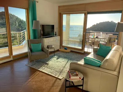a living room with a couch and a television and a balcony at Villa Nova Premium Apartment No 7 in Petrovac na Moru