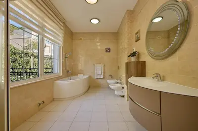 a bathroom with two toilets and a tub and a sink at Villa Sofiia with panoramic views of the old town in Budva