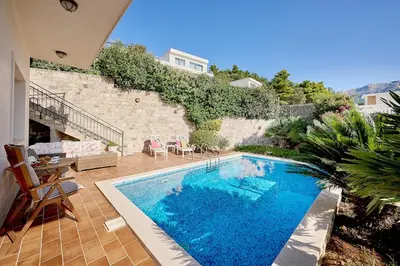a swimming pool in the middle of a yard at Villa Sofiia with panoramic views of the old town in Budva