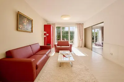 a living room with a couch and a table at Villa Sofiia with panoramic views of the old town in Budva