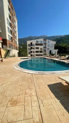 a large swimming pool in the middle of a building at Sea view apartment in Bečići in Becici