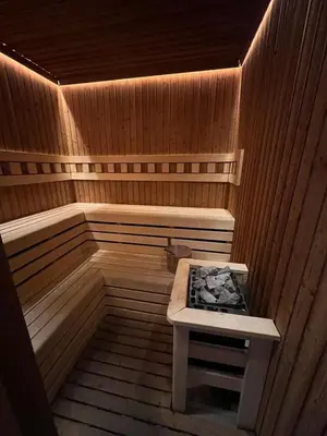 a sauna with a bench in the middle of it at Sea view apartment in Bečići in Becici