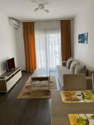 a living room with a couch and a tv at Aria Apartman 1 Ulcinj in Ulcinj