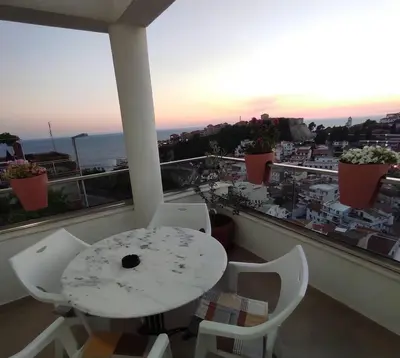 a table and chairs on a balcony with a view at Mediterano Apartments in Ulcinj