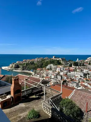 a view of a city with the ocean in the background at Nimanbegu Apartments in Ulcinj