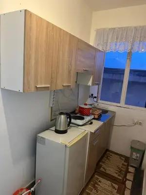 a small kitchen with a white refrigerator and a window at Nimanbegu Apartments in Ulcinj