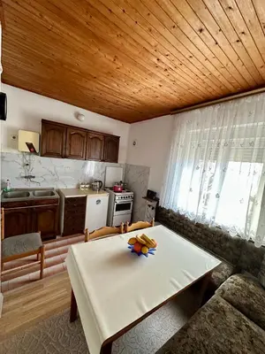 a kitchen with a table with fruit on it at Nimanbegu Apartments in Ulcinj