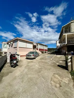 a car parked in a parking lot next to a building at Nimanbegu Apartments in Ulcinj