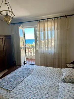 a bedroom with a bed with a view of the ocean at Nimanbegu Apartments in Ulcinj
