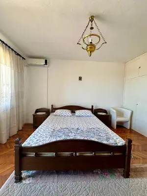 a bedroom with a bed and a chandelier at Nimanbegu Apartments in Ulcinj