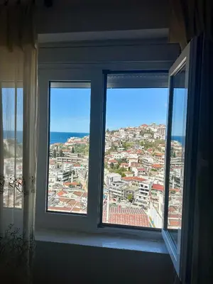 a window in a room with a view of a city at Nimanbegu Apartments in Ulcinj