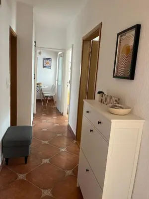 a room with a white dresser and a table at Cozy & Sunny 2-bedroom in best location in the city in Podgorica