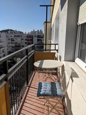 a balcony with a table and chairs on a balcony at Cozy & Sunny 2-bedroom in best location in the city in Podgorica