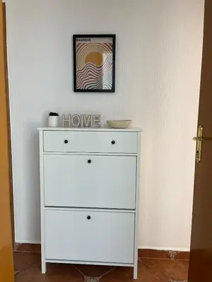 a white dresser with a picture on top of it at Cozy & Sunny 2-bedroom in best location in the city in Podgorica