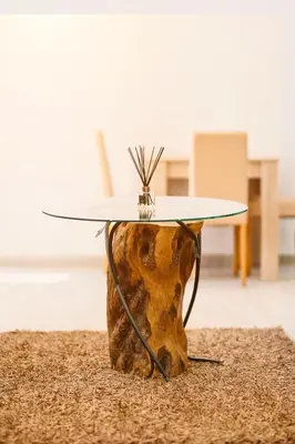 a table with a surfboard on top of a tree stump table at Eman Resort & Villas in Ulcinj