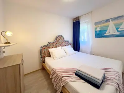 a bedroom with a bed and a desk and a bed sidx sidx sidx at Sun&Sea Petrovac in Petrovac na Moru