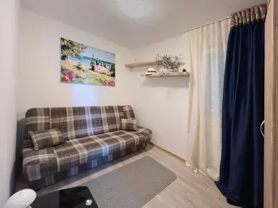 a living room with a couch and a window at Sun&Sea Petrovac in Petrovac na Moru