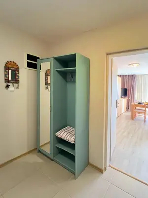 a green cabinet in a room with a mirror at Sun&Sea Petrovac in Petrovac na Moru