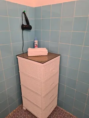 a cabinet in a bathroom with a phone on it at Casa-Cristiano in Sutomore