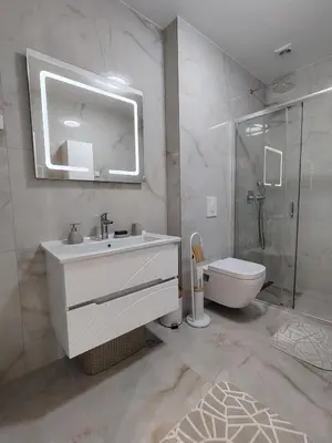 a bathroom with a sink and a toilet and a mirror at Seratlić Lux 27 in Bar