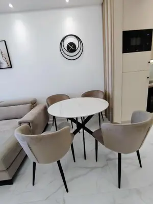 a living room with a table and chairs and a couch at Seratlić Lux 27 in Bar