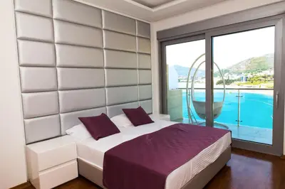 a bedroom with a bed and a large window at Hotel Ponta Nova in Budva