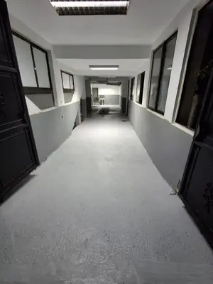 an empty hallway in an office building with windows at Kolovic Susanj in Bar