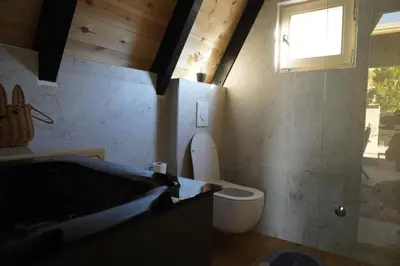 a bathroom with a toilet and a sink and a window at Guest Houses Edita in Donji Štoj
