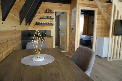 a dining room with a wooden table and chairs at Guest Houses Edita in Donji Štoj