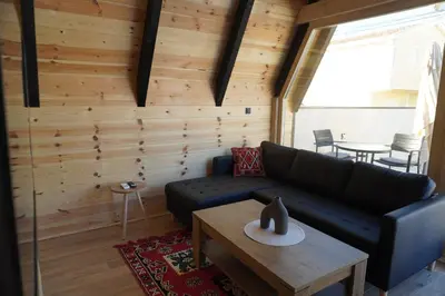 a living room with a black couch and a table at Guest Houses Edita in Donji Štoj