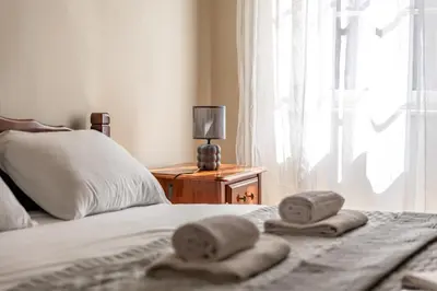 a bed with two towels on it with a window at Apartment NICO in Kotor