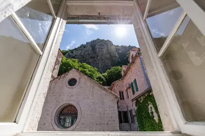 a view through a window of a church at Apartment NICO in Kotor
