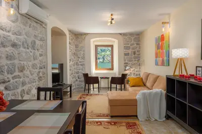 a living room with a couch and a table at Historic Waterfront House in Muo
