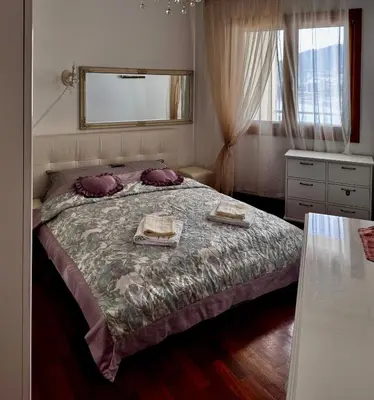 a bedroom with a bed with two towels on it at Apartament Rafailovici Budva in Budva