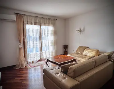 a living room with a couch and a table at Apartament Rafailovici Budva in Budva