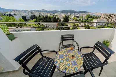 a balcony with two chairs and a purse on it at Adriatic Lux Apartment in Bar