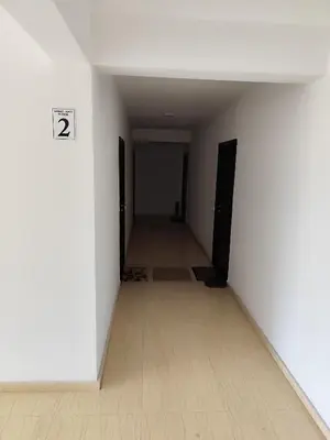 an empty hallway with two doors and a tile floor at Big Blue Apartment in Ulcinj