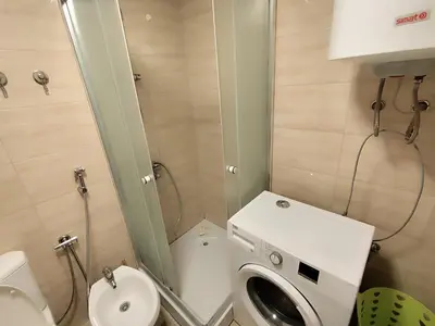 a small bathroom with a toilet and a sink at Big Blue Apartment in Ulcinj
